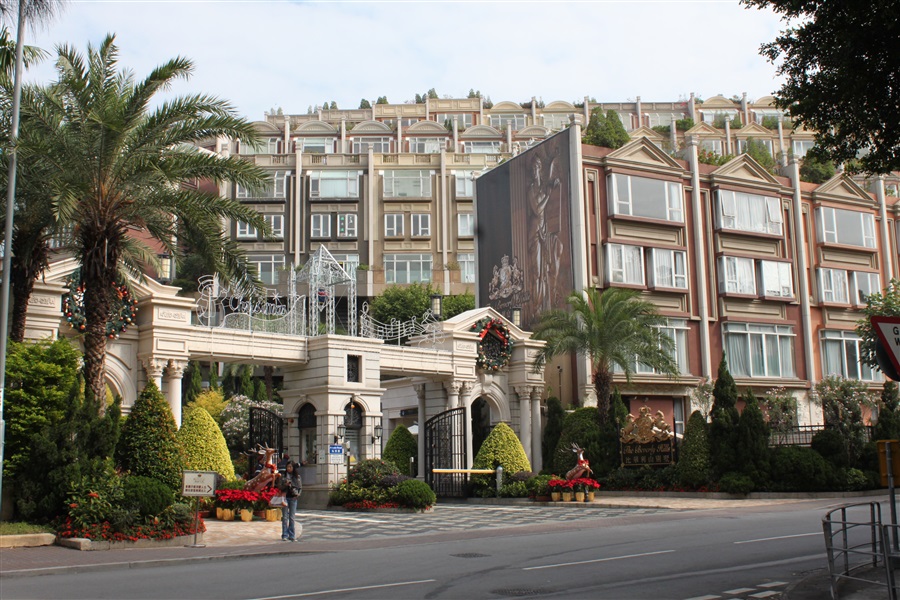 The beverly hill building with palm trees and a large building